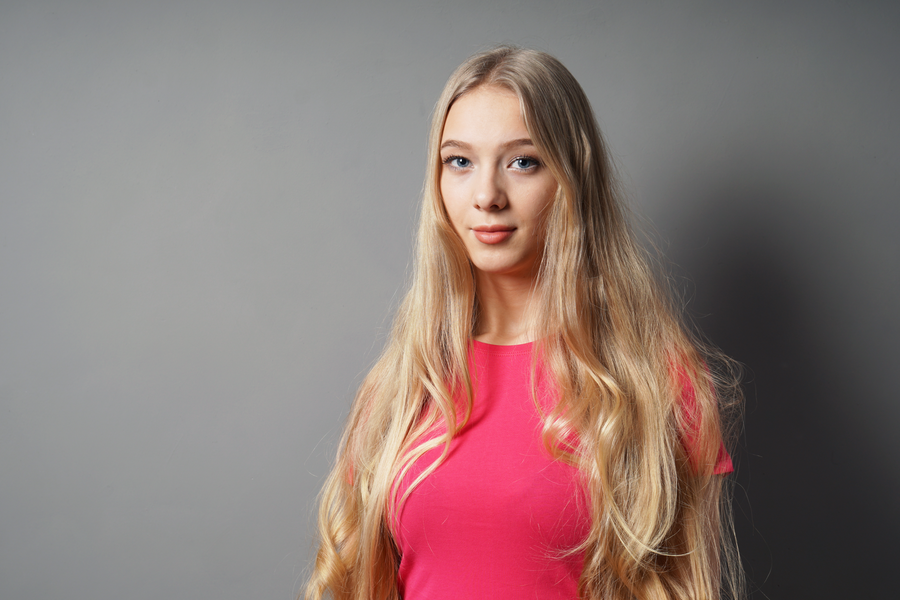 Woman with brown hair and blonde highlights