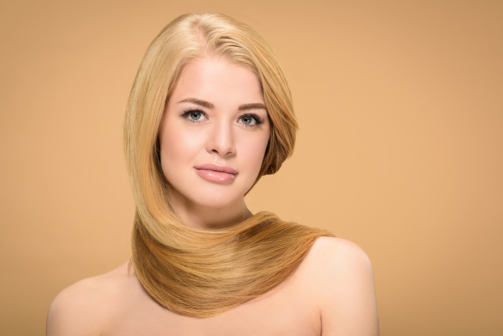Long flowing platinum blonde hair style with soft curls